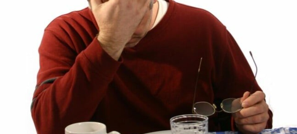 depressed man dines at empty plate