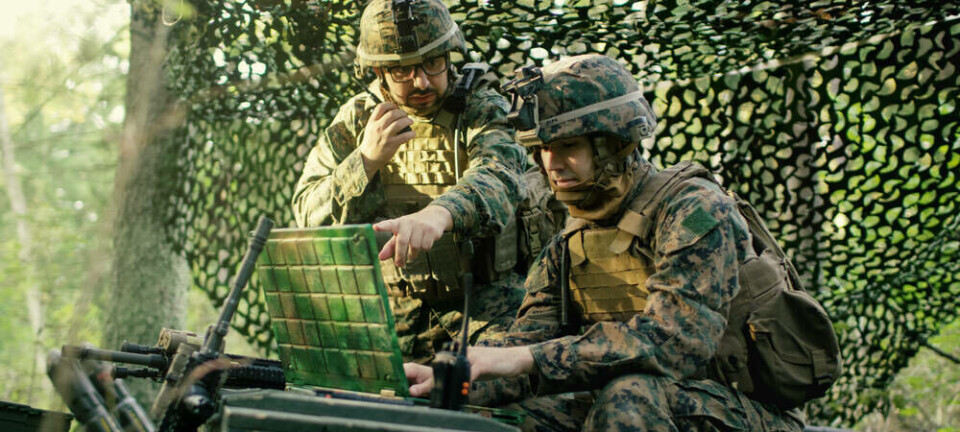 Generic photo of US Army like soldiers using a laptop in the field