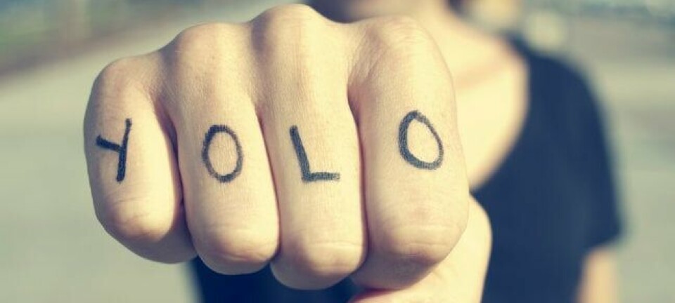 Man with YOLO tattooed on his knuckles prepares to punch the viewer (of the pic). Photo by Shutterstock