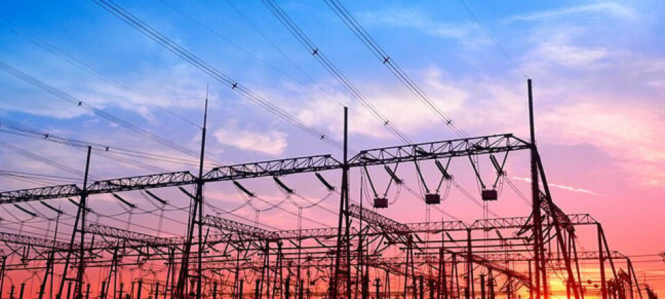 High voltage power grid, in the sunset. Photo by SHutterstock