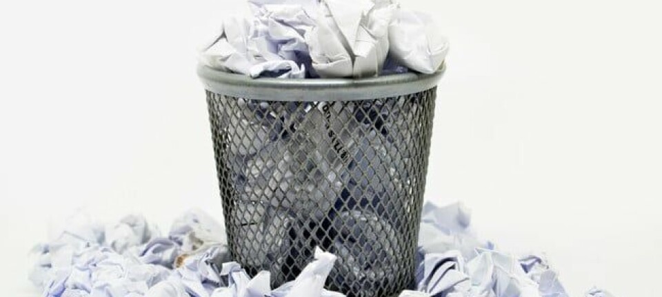 Wire wastepaper bin filled with scrunched up paper. Photo by Shutterstock
