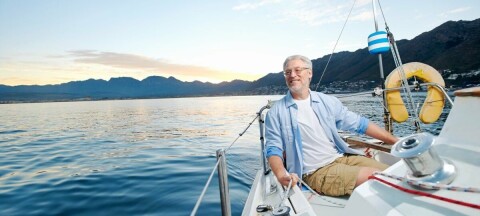 Grey haired man on a yacht