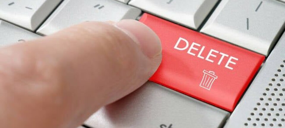 A finger pressing a delete key