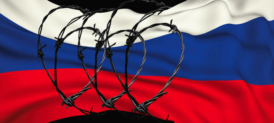 Illustration of barbed wire around the Russian flag