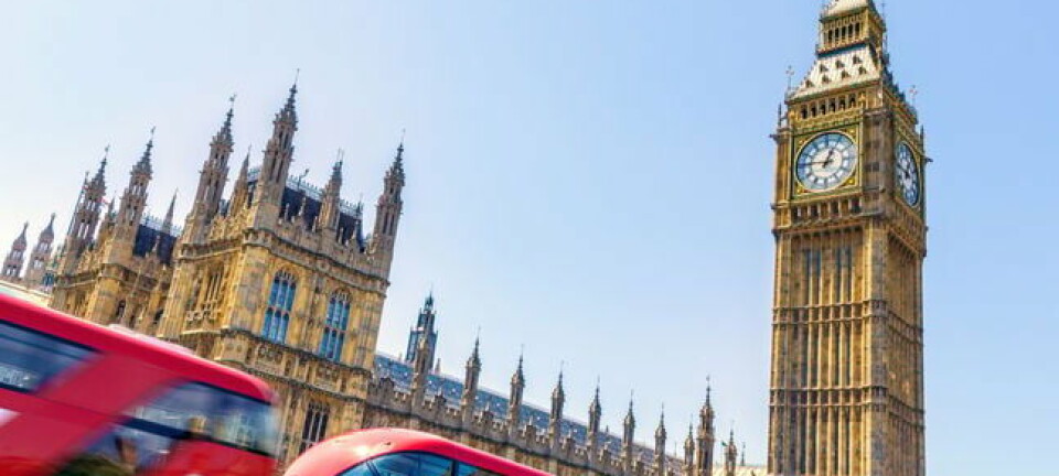 parliament buildings with buses going by