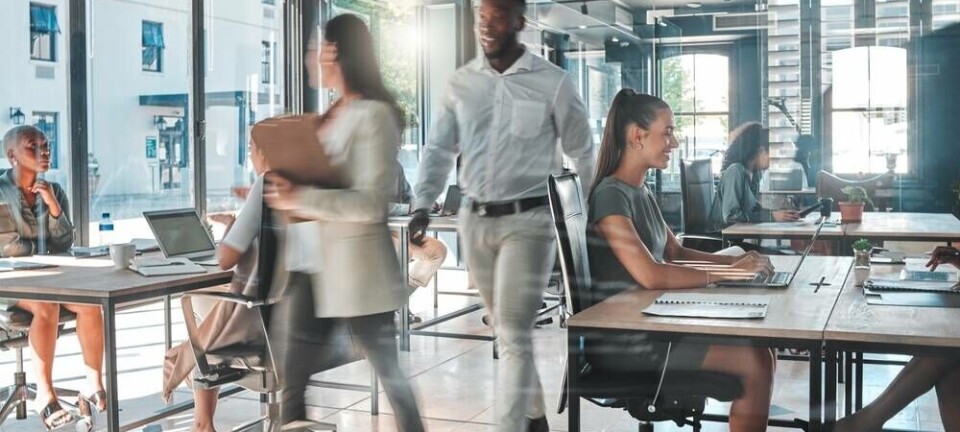 Generic busy office scene of workers and PCs