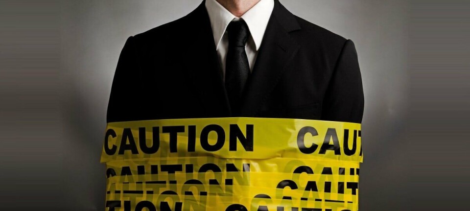 Caution tape wrapped around man in suit