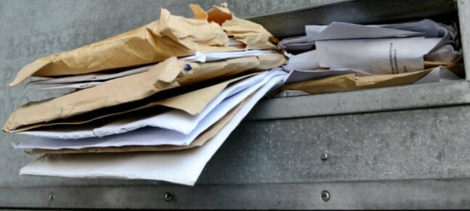 letters stuffed in a mailbox. Photo by SHutterstock