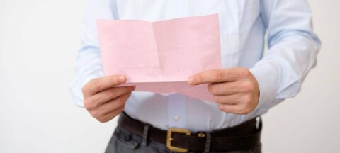 Shutterstock image of a man with a pink slip