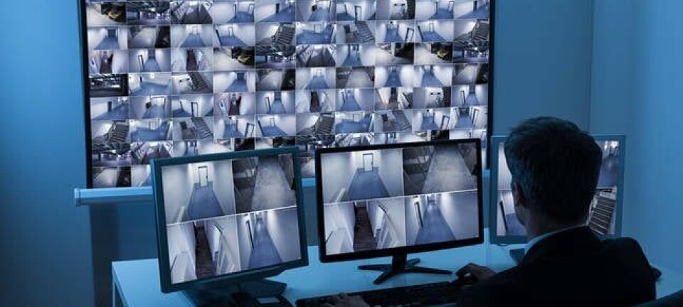 security chap watches footage of multiple cctv feeds