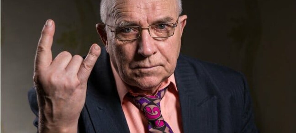 Elderly man making a horns gesture