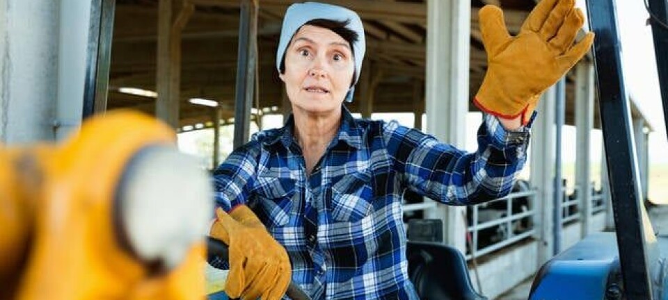 farmer sitting on a tractor at the cowfarm