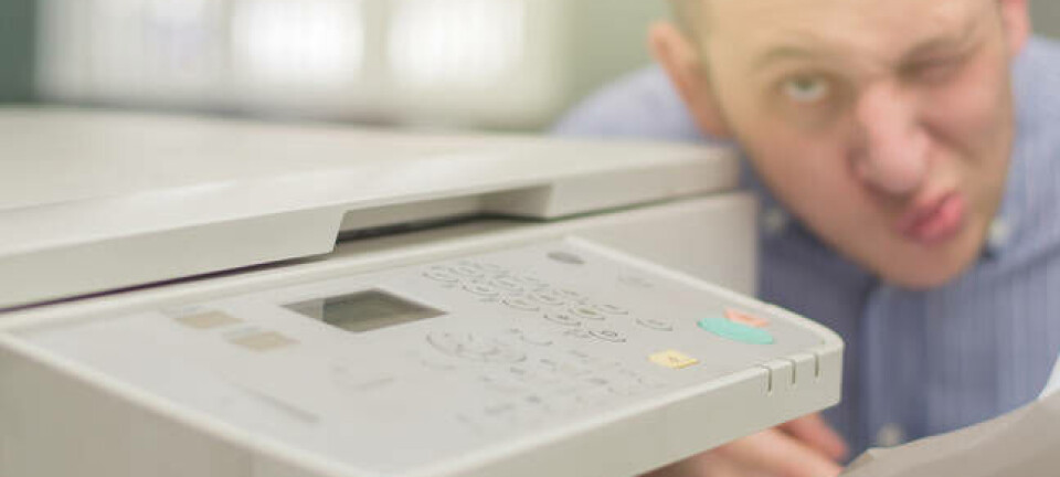 worried guy squints at printer