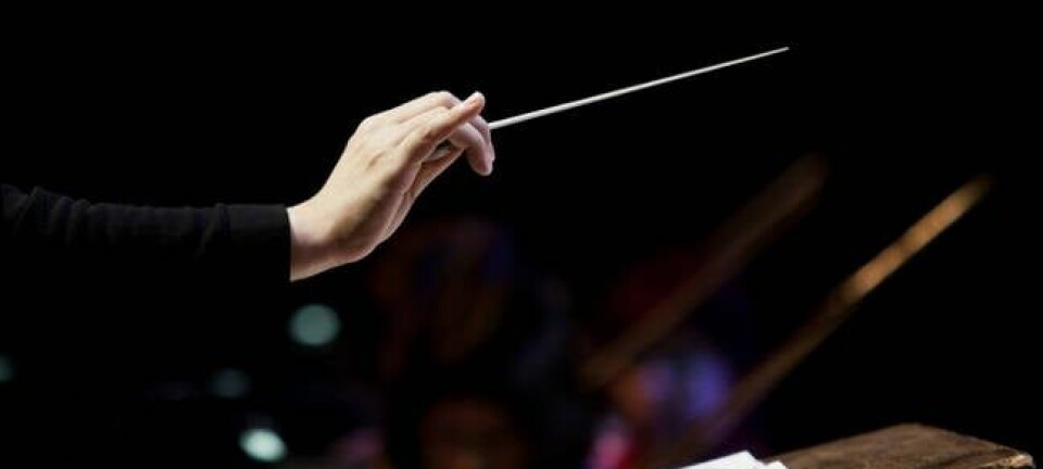 conductor's hand on a black background