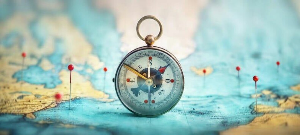 A traditional compass placed on top of a map