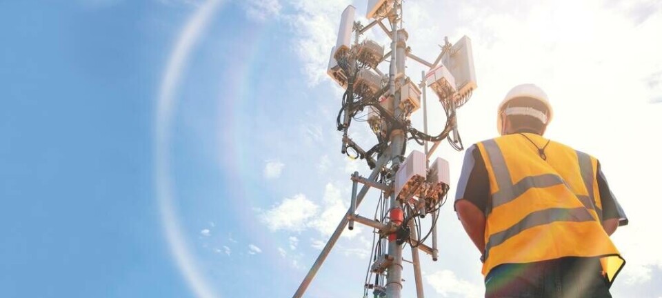 Someone standing by some 5G towers
