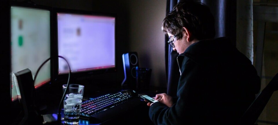 Teenaged boy on computer in his room late at night