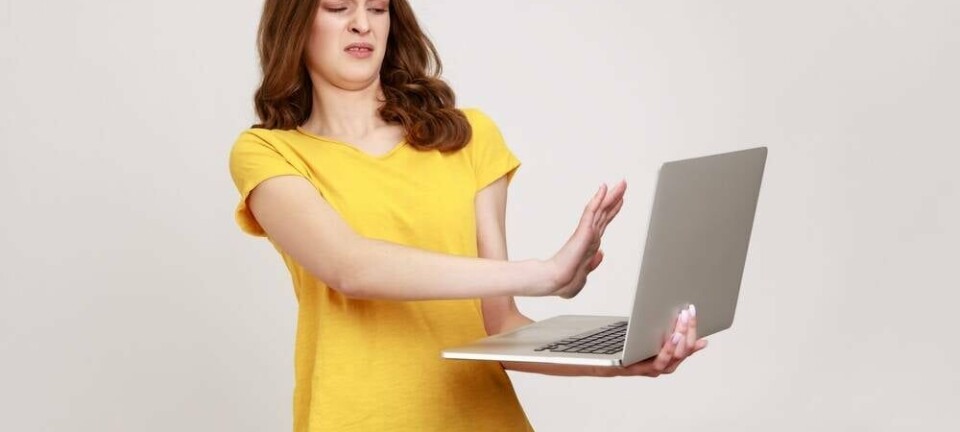 Someone holding away a laptop in disgust