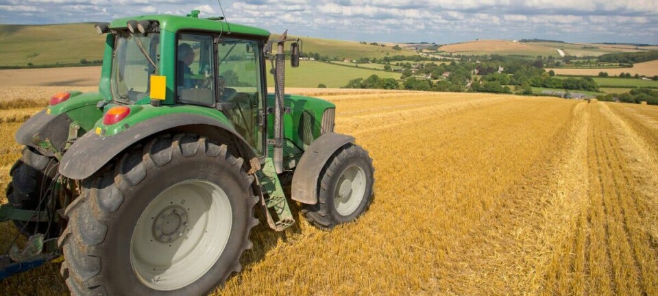A farmer running their tractor through a field