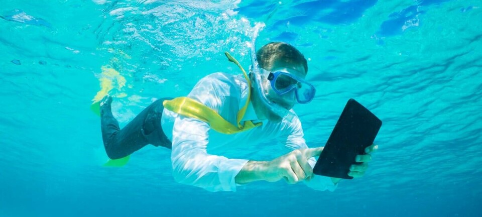 Someone trying to use a tablet computer under water
