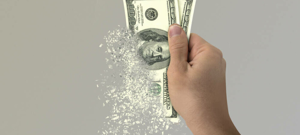 Someone holding up money disappearing in their hand