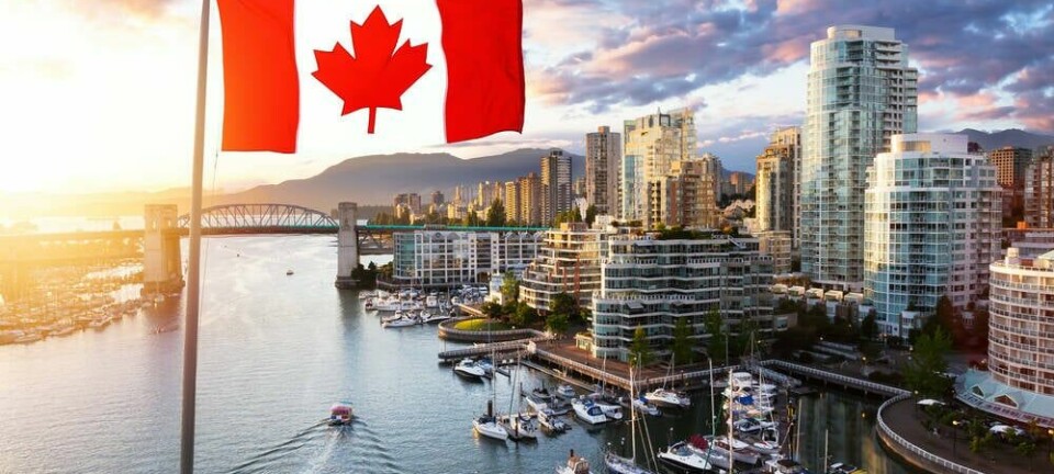Canadian flag flying over downtown Vancouver, British Columbia, Canada
