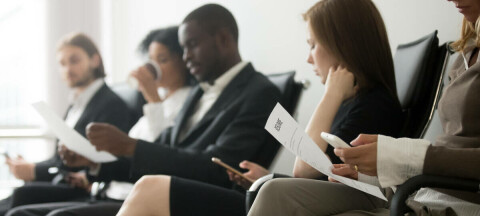 A line of people waiting for a job interview