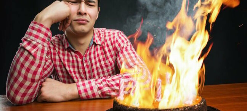 celebrating in front of flaming birthday cake