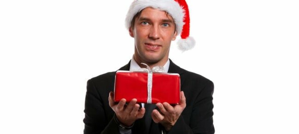 hesitant looking man offers up christmas present
