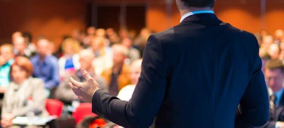 man gives lecture faces crowd