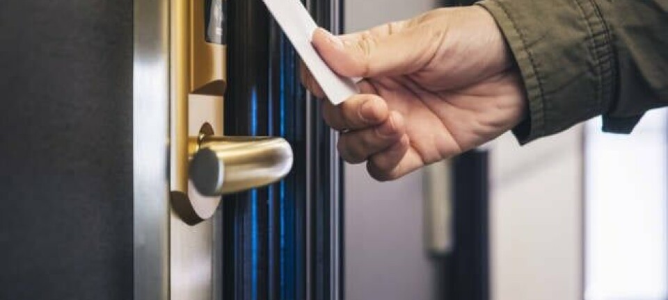 Man opens hotel room with key card