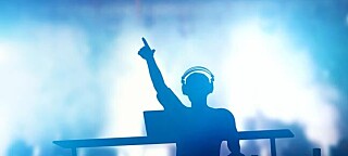 DJ at mixing deck. Photo by Shutterstock