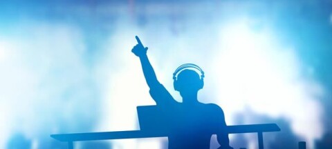 DJ at mixing deck. Photo by Shutterstock