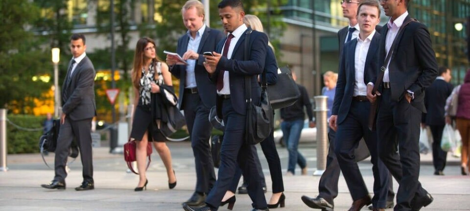 Canary Wharf business life. Group of business people going home after working day.