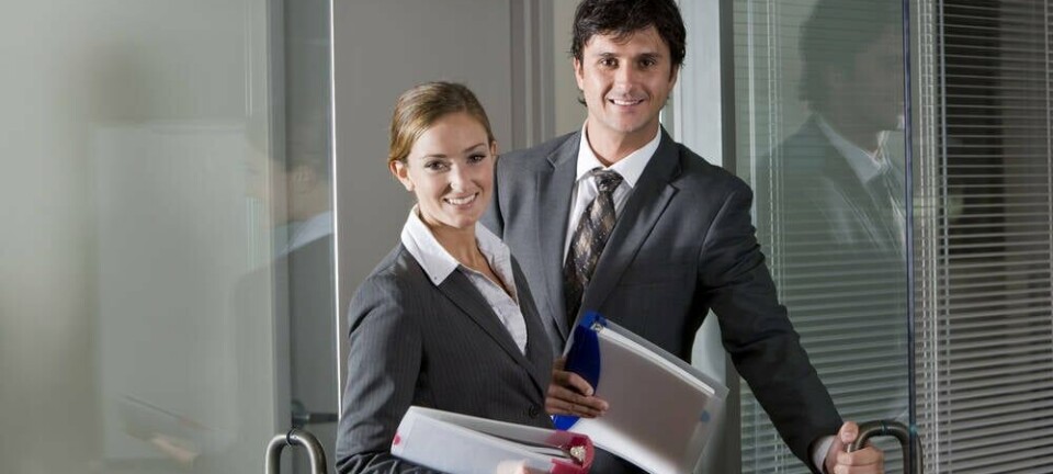 Two sales or business people at the door to an office, walking in