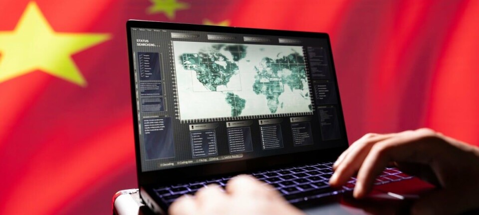 Chinese flag behind laptop with world map