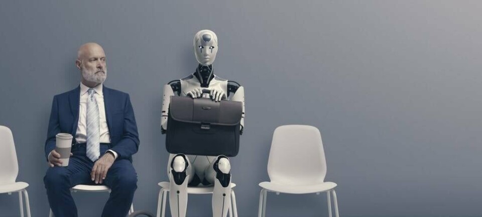 A human waiting for their job interview sitting next to a robot that has also applies