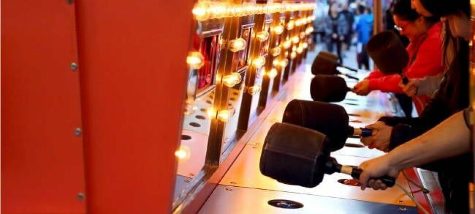 People playing whack-a-mole game