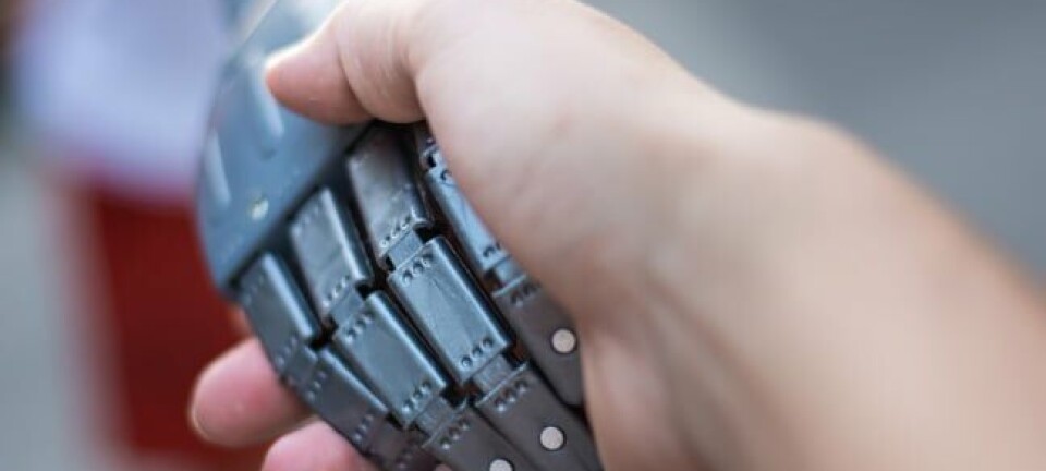 Robot hand human handshake photo via Shutterstock