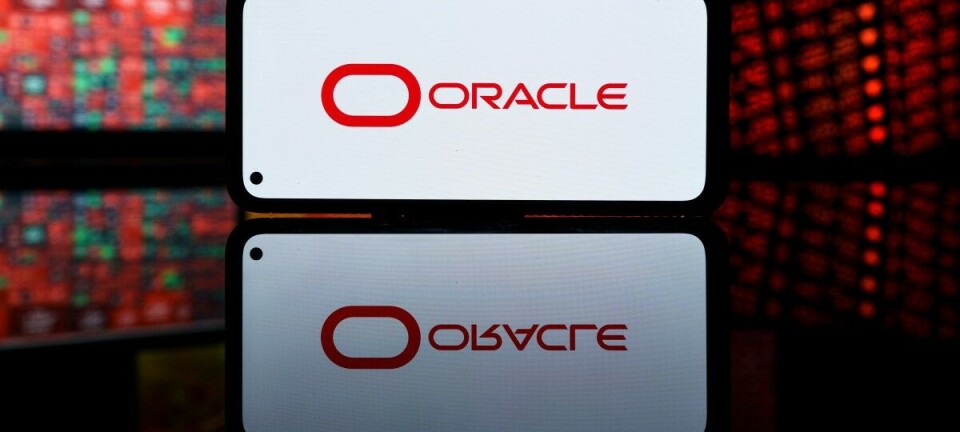 Oracle logo on smartphone floating over stock market data feeds