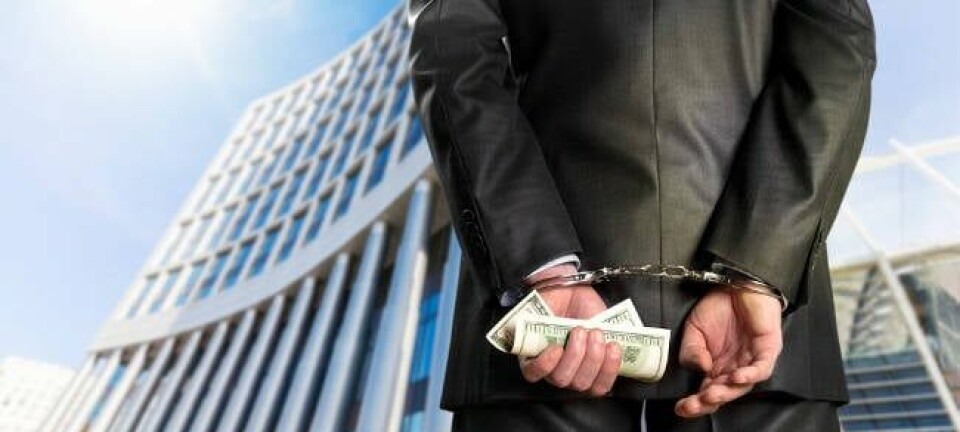 A businessman in handcuffs