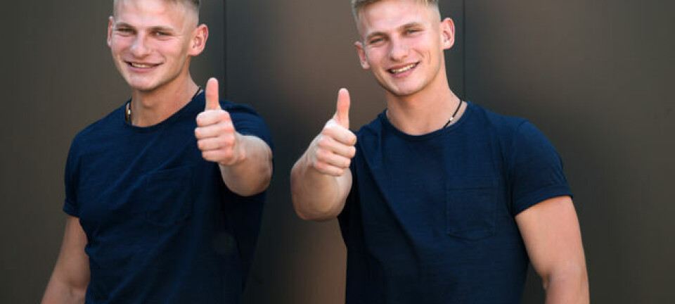 twin men give the thumbs up