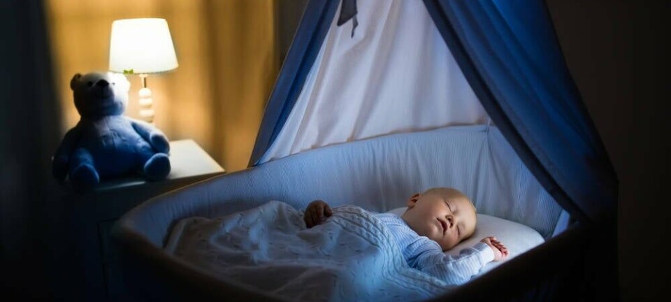 A baby sleeping in a crib