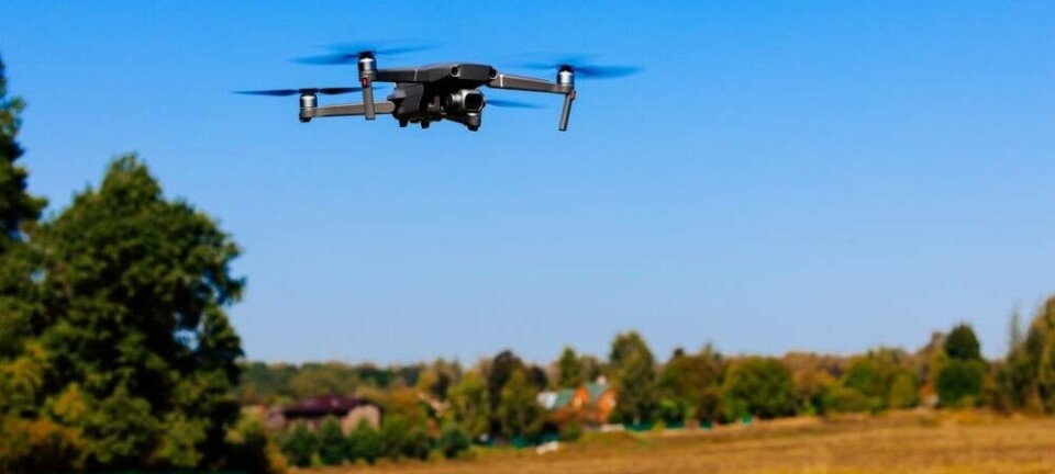 Close-up view of drone flying over agricultural field. Flying drone quadcopter over the harvest field. Photo: NBLX/ Shutterstock