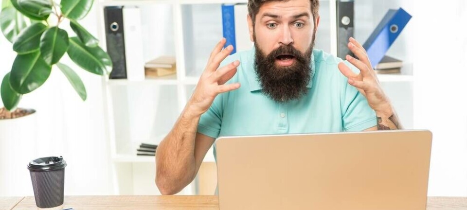 Stunned programmer looking at computer