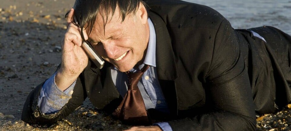 calling from cellphone, wet on a beach. Pic credit Andrew Lever / Shutterstock
