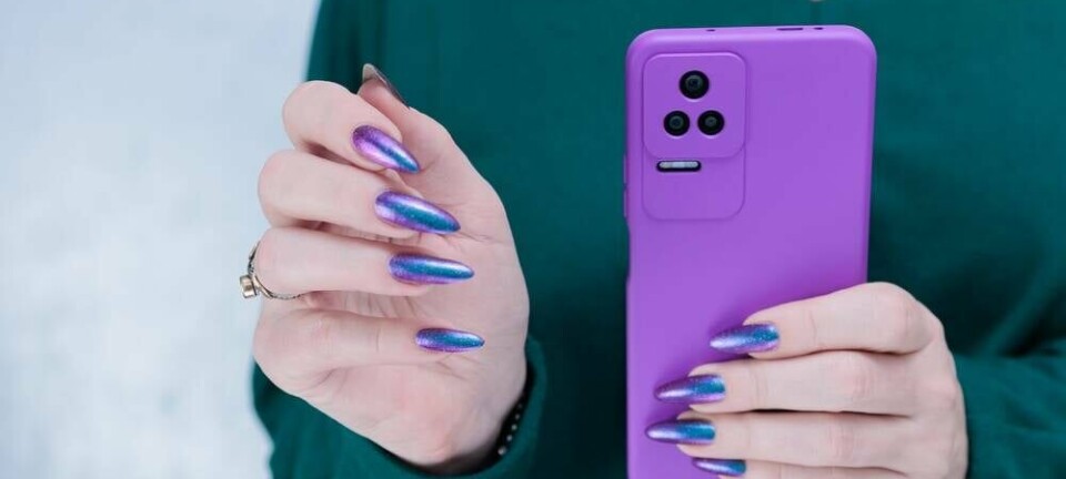 woman with long fingernails clutching smartphone