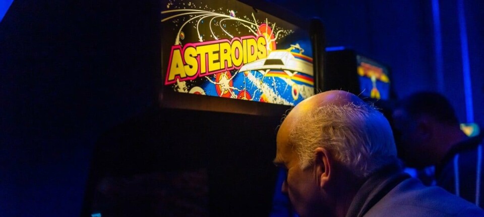 Old chap playing vintage video game 'Asteroids'