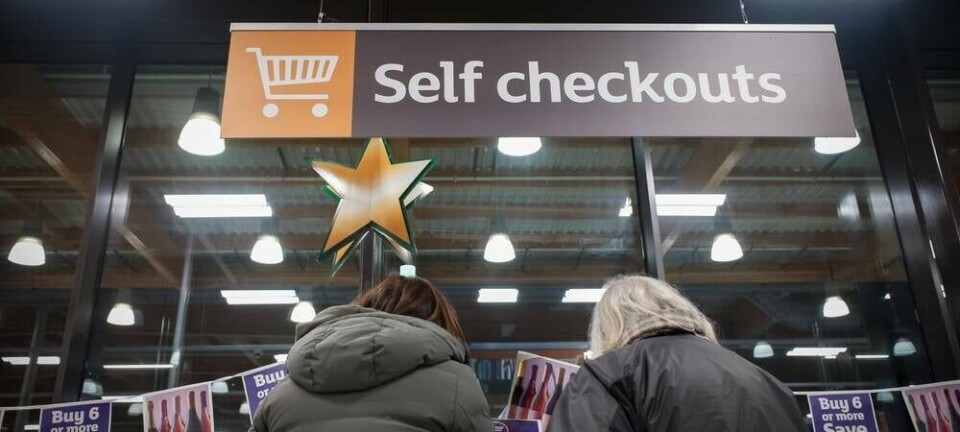 Self checkout sign and shoppers at Sainsburys. Pic credit: DacologyPhoto / Shutterstock
