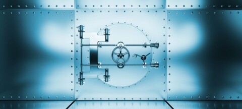 A blue-toned metal vault door with a circular locking mechanism set in a riveted steel wall